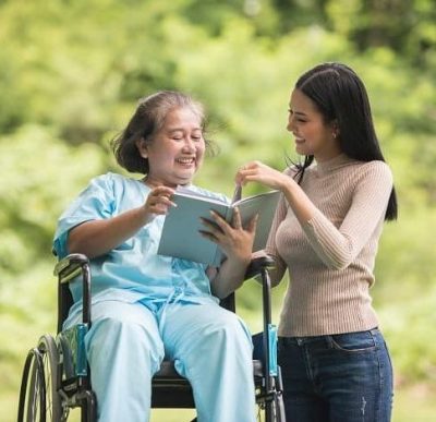 Taking care of old woman on wheel chair