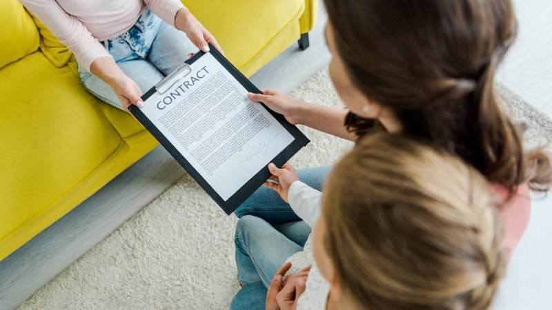 parent showing guidelines to potential babysitter